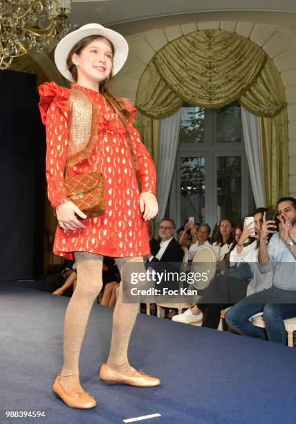 Model walks the runway during the Bleu Comme Gris Childrenswear show At Hotel Ritz on June 30, 2018 in Paris, France.