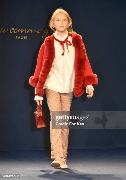 Model walks the runway during the Bleu Comme Gris Childrenswear show At Hotel Ritz on June 30, 2018 in Paris, France.