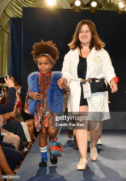 Model walks the runway during the Bleu Comme Gris Childrenswear show At Hotel Ritz on June 30, 2018 in Paris, France.