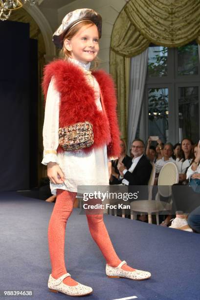 Model walks the runway during the Bleu Comme Gris Childrenswear show At Hotel Ritz on June 30, 2018 in Paris, France.