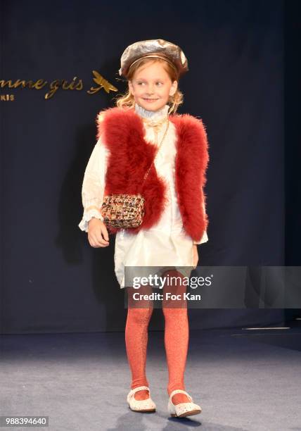 Model walks the runway during the Bleu Comme Gris Childrenswear show At Hotel Ritz on June 30, 2018 in Paris, France.