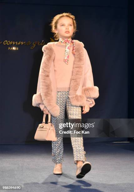 Model walks the runway during the Bleu Comme Gris Childrenswear show At Hotel Ritz on June 30, 2018 in Paris, France.