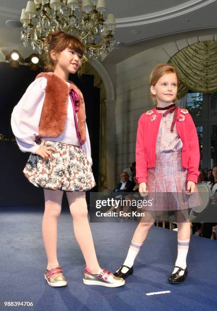 Model walks the runway during the Bleu Comme Gris Childrenswear show At Hotel Ritz on June 30, 2018 in Paris, France.