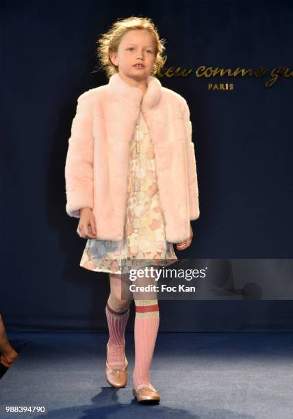 Model walks the runway during the Bleu Comme Gris Childrenswear show At Hotel Ritz on June 30, 2018 in Paris, France.