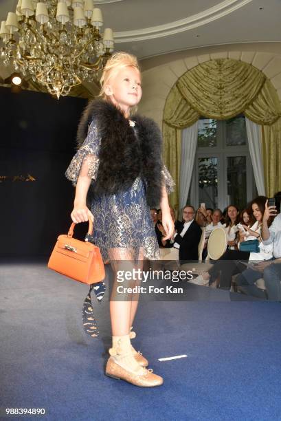 Model walks the runway during the Bleu Comme Gris Childrenswear show At Hotel Ritz on June 30, 2018 in Paris, France.