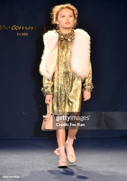 Model walks the runway during the Bleu Comme Gris Childrenswear show At Hotel Ritz on June 30, 2018 in Paris, France.