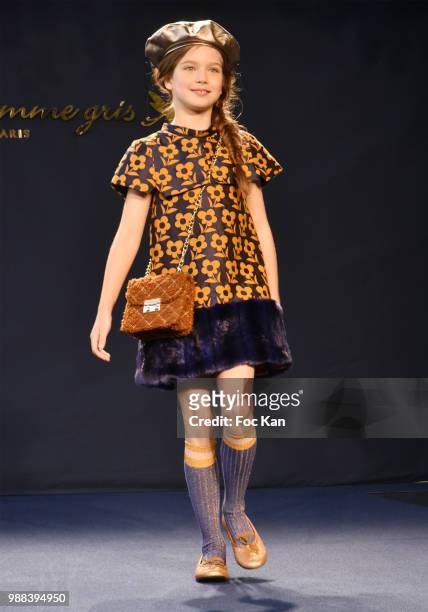 Model walks the runway during the Bleu Comme Gris Childrenswear show At Hotel Ritz on June 30, 2018 in Paris, France.