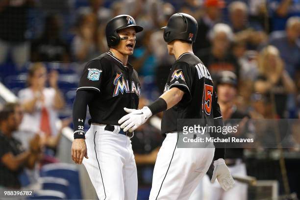 Derek Dietrich of the Miami Marlins celebrates with Brian Anderson after he hit a two-run home run in the sixth inning against the New York Mets at...