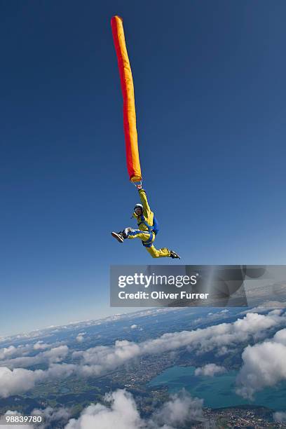 man in freestyle position flying with air tube. - swiss air aircraft fotografías e imágenes de stock