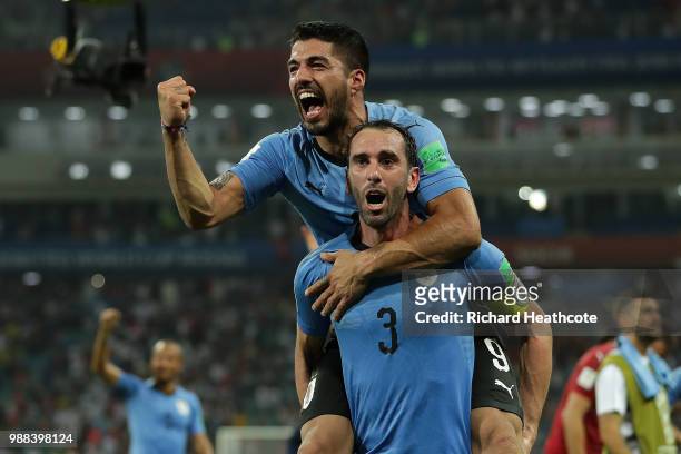 Luis Suarez and Diego Godin of Uruguay celebrate victory at the final whistle during the 2018 FIFA World Cup Russia Round of 16 match between Uruguay...