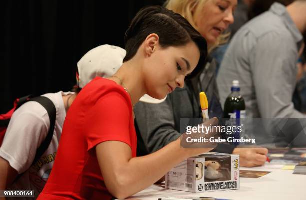 Actress Brianna Hildebrand autographs a Negasonic Teenage Warhead Pop! Vinyl figure during the sixth annual Amazing Las Vegas Comic Con at the Las...