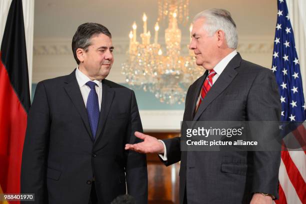 United States Secretary of State Rex Tillerson speaks with German Minister of Foreign Affairs Sigmar Gabriel, during a press conference on the...
