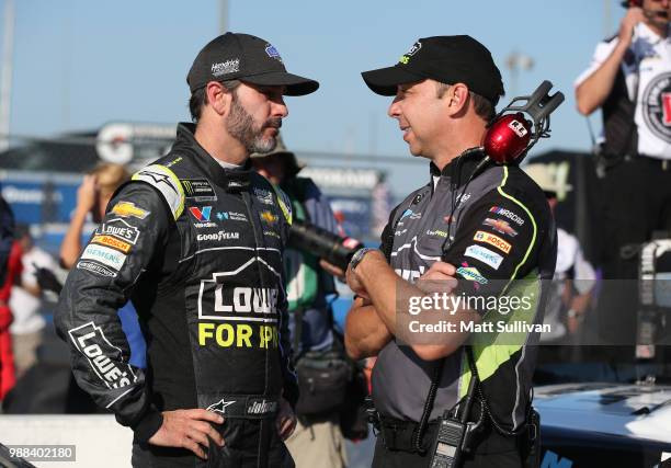 Jimmie Johnson, driver of the Lowe's for Pros Chevrolet, talks to his crew chief, Chad Knaus, during qualifying for the Monster Energy NASCAR Cup...