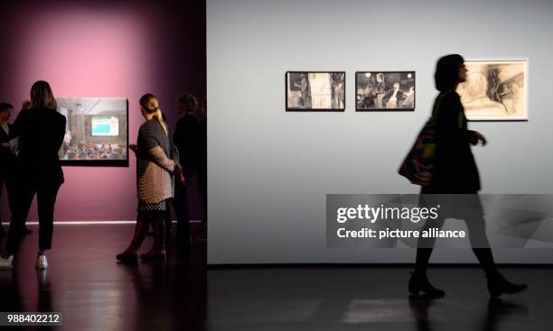 Visitors walk past paintings during a press preview of the exhibition 'Patrick Angus. Private Show' at the Kunstmuseum in Stuttgart, Germany, 30...