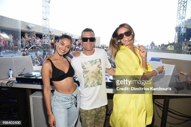 Model Shanina Shaik, DJ Kaskade and Model Heidi Klum pose for a photo together during HQ2 Beachclub Opening at Ocean Resort Casino on June 30, 2018...