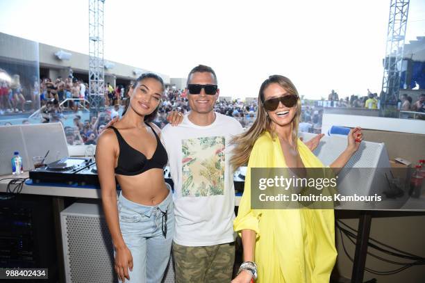 Model Shanina Shaik, DJ Kaskade and Model Heidi Klum pose for a photo together during HQ2 Beachclub Opening at Ocean Resort Casino on June 30, 2018...