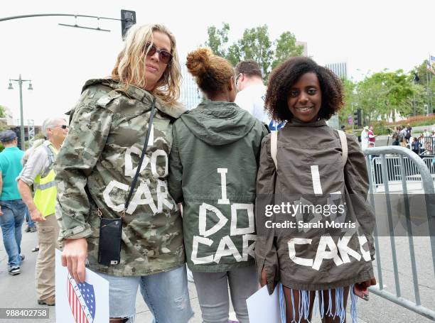 Demonstrators wear jackets reading "I do care" at the Families Belong Together - Freedom For Immigrants March at Los Angeles City Hall on June 30,...