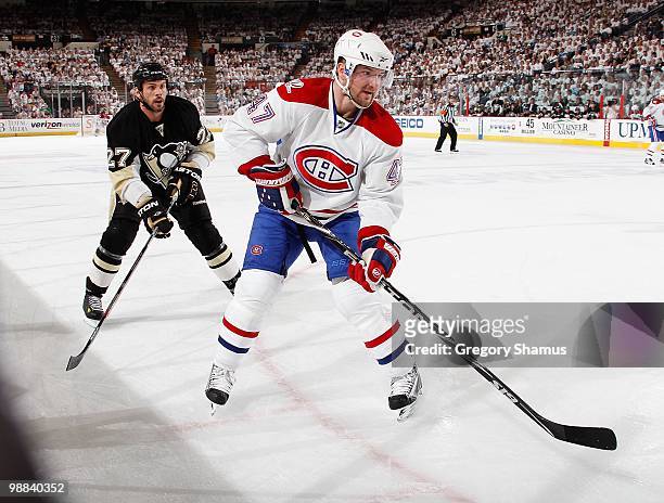 Marc-Andre Bergeron of the Montreal Canadiens skates in front of Craig Adams of the Pittsburgh Penguins in Game One of the Eastern Conference...