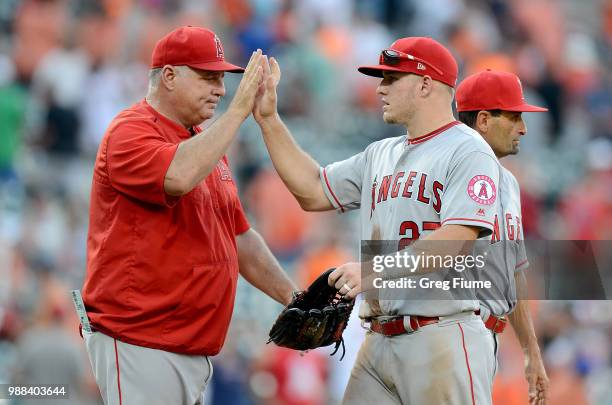 Manager Mike Scioscia of the Los Angeles Angels celebrates with Mike Trout after a 6-2 victory against the Baltimore Orioles at Oriole Park at Camden...