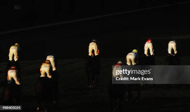 Jockeys are caught in the late afternoon light after race 9 during Sydney racing at Rosehill Gardens on June 30, 2018 in Sydney, Australia.