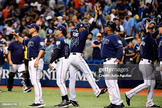 Sergio Romo of the Tampa Bay Rays celebrates with first base coach Ozzie Timmons after a 5-2 win against the Houston Astros on June 30, 2018 at...