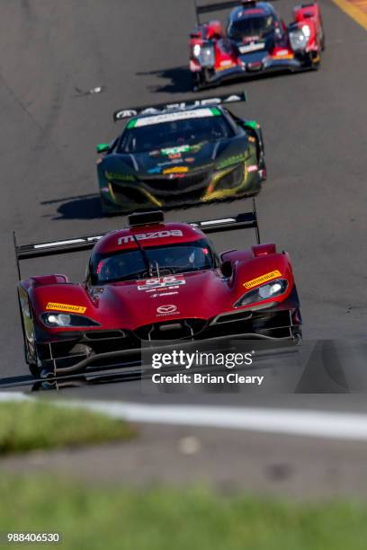 The Mazda DPi of Jonathan Bomarito, Harry Tincknell, of Great Britain, and Spencer Pigot races on the track during practice for the Sahlens Six Hours...