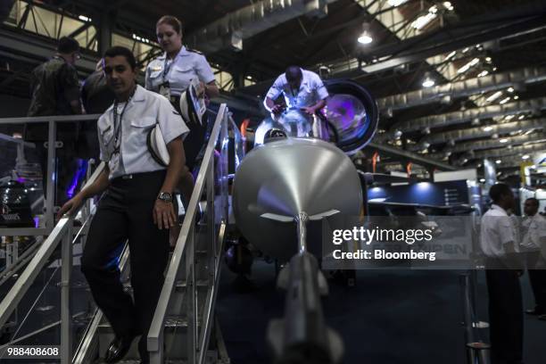 Attendees view the Saab AB F-39 Gripen fighter jet during the Rio International Defense Exhibition in Rio de Janeiro, Brazil, on Friday, June 29,...