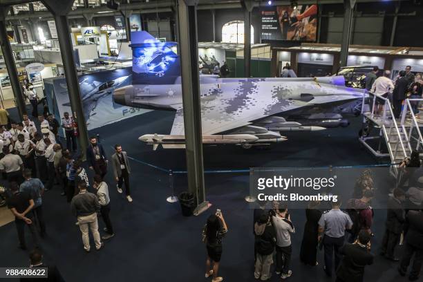 Attendees gather around the Saab AB F-39 Gripen fighter jet during the Rio International Defense Exhibition in Rio de Janeiro, Brazil, on Friday,...