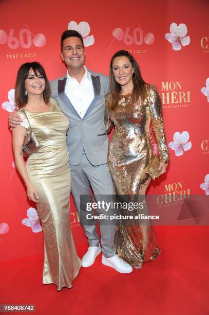 Model Gitta Saxx , Dutch pop singer Eloy de Jong and entrepreneur Simone Ballack arrive at the gala of the mon Cheri Barbara DAy at the Postpalast in...