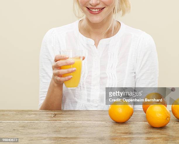 close up of female with glass of orange juice - orangensaft stock-fotos und bilder