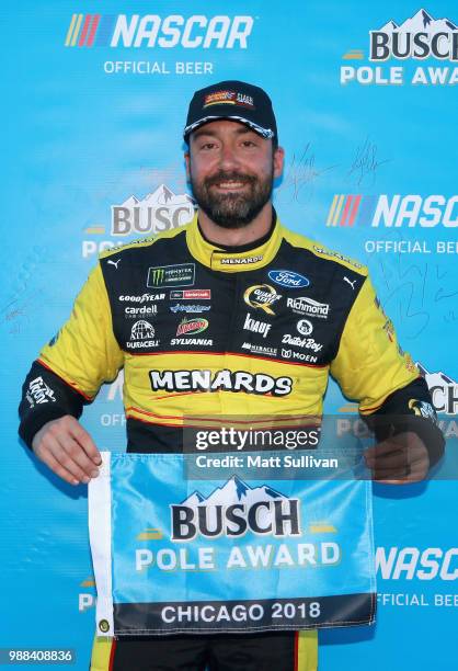 Paul Menard, driver of the Menards/Sylvania Ford, poses with the Busch Pole Award after posting the fastest lap during qualifying for the Monster...