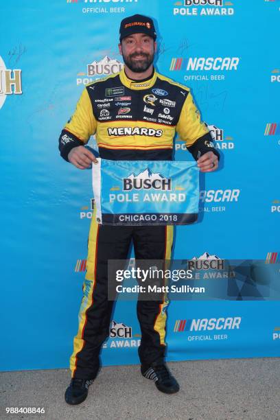 Paul Menard, driver of the Menards/Sylvania Ford, poses with the Busch Pole Award after posting the fastest lap during qualifying for the Monster...