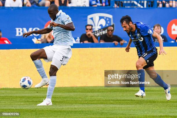 Montreal Impact forward Matteo Mancosu can,T catch up to Sporting Kansas City defender Ike Opara who gains control of the ball during the Sporting...