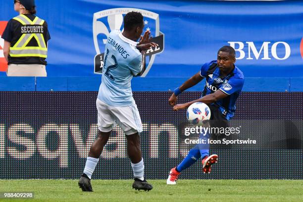 Montreal Impact defender Chris Duvall kicks the ball in front of Sporting Kansas City forward Gerso Fernandes during the Sporting Kansas City versus...