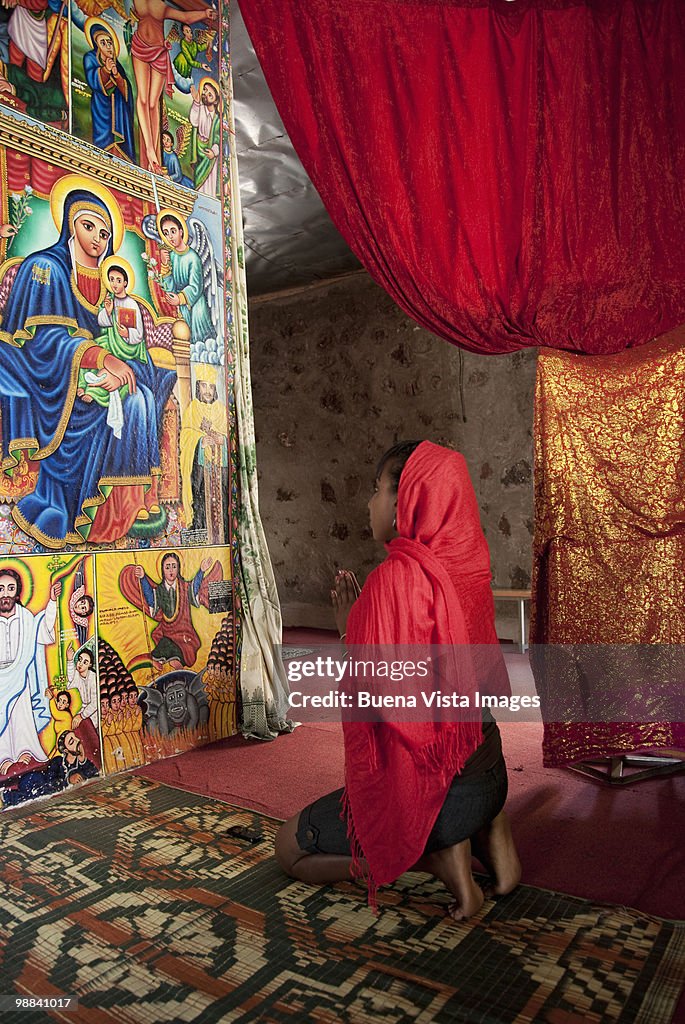 Woman praying in Monastery