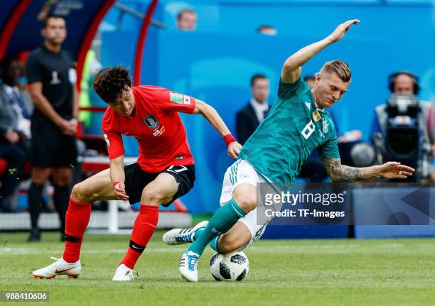 Jaesung Lee of Korea Republic and Toni Kroos of Germany battle for the ball during the 2018 FIFA World Cup Russia group F match between Korea...