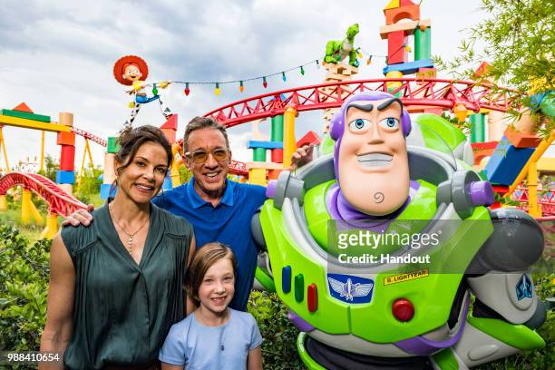 In this handout image provided by Walt Disney World Resort,actor Tim Allen, his wife Jane and daughter Elizabeth pose with Buzz Lightyear during a...