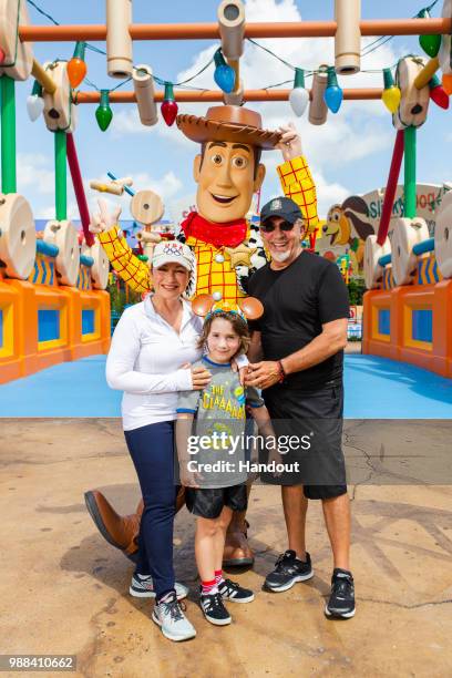 In this handout image provided by Walt Disney World Resort, Gloria Estefan, Emilio Estefan and their grandson, Sasha, pose with Woody while...