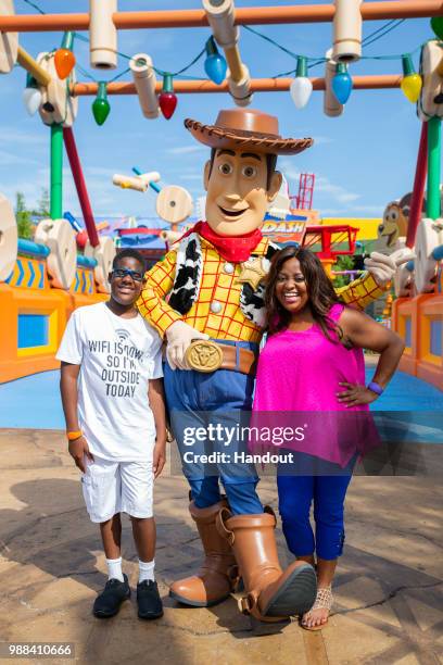 In this handout image provided by Walt Disney World Resort, actress Sherri Shepherd and son, Jeffrey, share a special moment with Woody while...