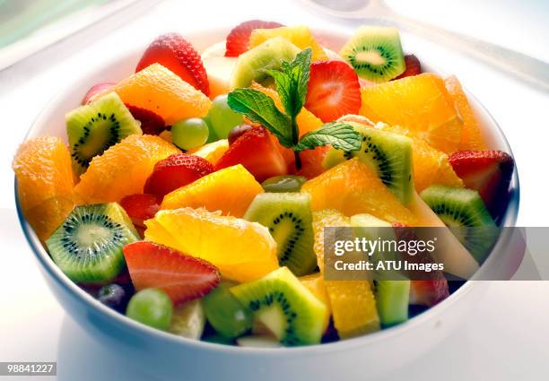 fruit salad - kiwi berries stock-fotos und bilder