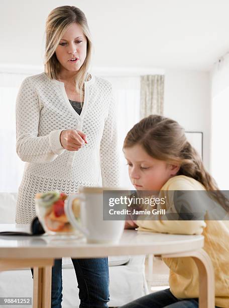 mother scolding daughter - ammonite foto e immagini stock