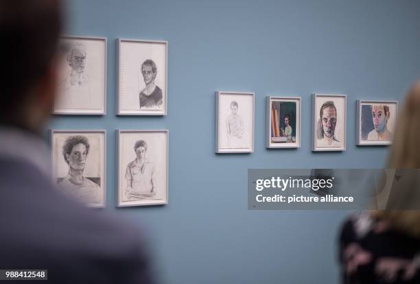 Visitors walk past drawings during a press preview of the exhibition 'Patrick Angus. Private Show' at the Kunstmuseum in Stuttgart, Germany, 30...