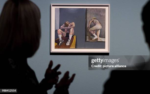 Visitors stand in front of a painting during a press preview of the exhibition 'Patrick Angus. Private Show' at the Kunstmuseum in Stuttgart,...