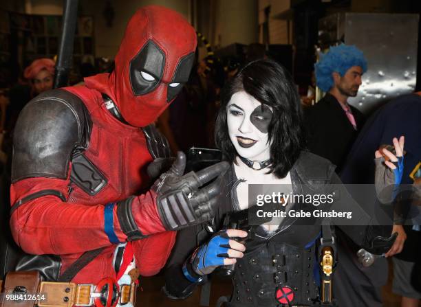 Maxx Dakota of Nevada, dressed as the character Deadpool and Tegan Wills of Texas, dressed as the character Domino from the "Deadpool 2" movie, take...