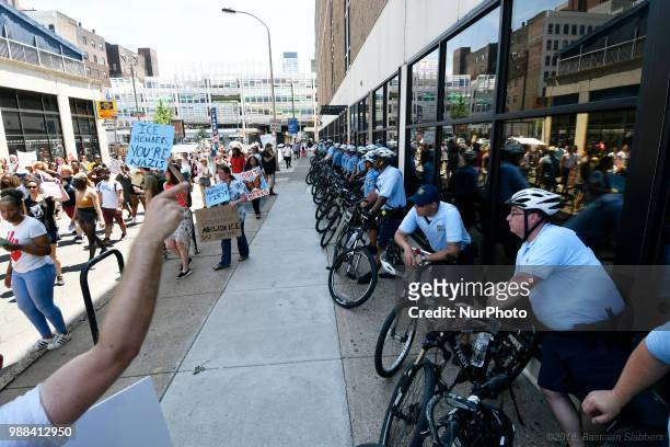 Police officers line the building as a group of protestors rallies at a local Dept of Homeland Security Immigration Field Office, in Philadelphia,...