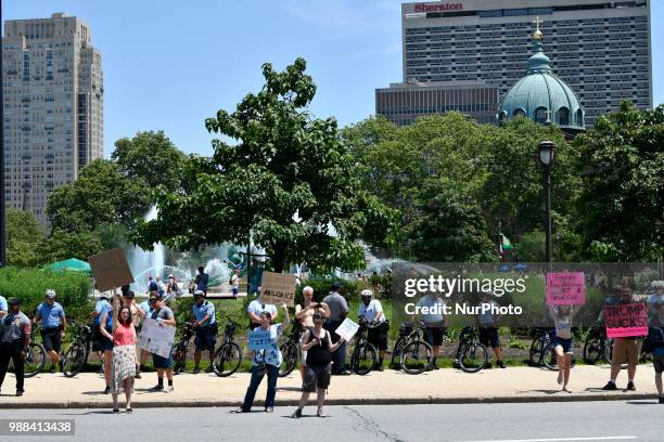 Protestors counter a Trump supporter, looking on from the side, as thousands participate in a rally to protest the Trump's administration immigration...