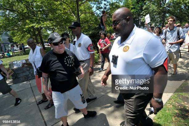 Officers with the Philadelphia Police Dept. Civil Affairs unit remove an unnamed individual from the crowd as thousands participate in a rally to...