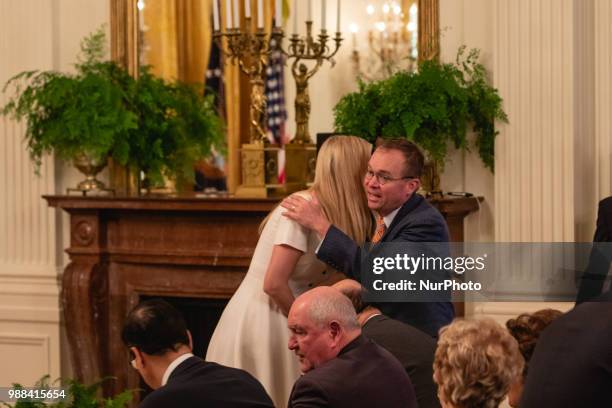 Ivanka Trump, daughter and assistant to U.S. President Donald Trump, and Director of the Office of Management and Budget Mick Mulvaney, hug before...