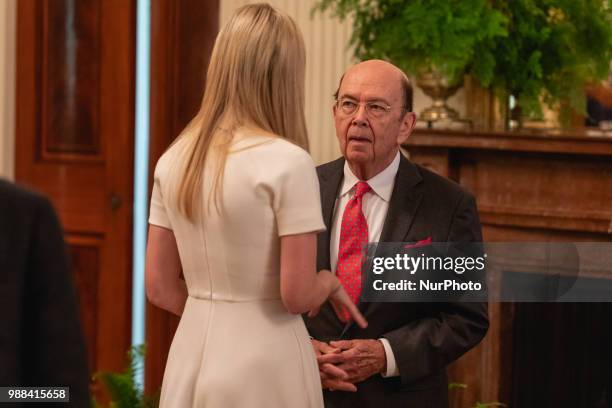 Ivanka Trump, daughter and assistant to U.S. President Donald Trump, and Commerce Secretary Wilbur Ross, speak before President Trump's event...