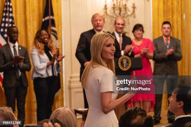 Ivanka Trump, daughter and assistant to U.S. President Donald Trump, stands as she's acknowledged by President Trump, during his event celebrating...